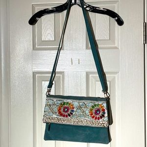 Bohemian shoulder/crossbody bag with sequin detailing and large zipper interior.